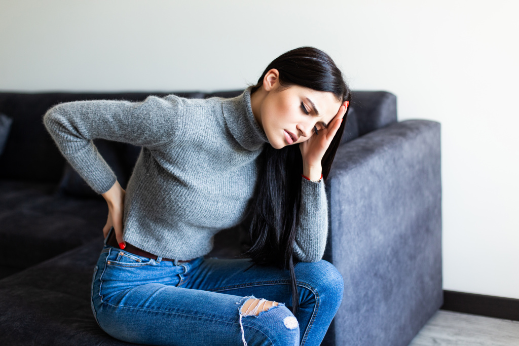 боль.jpg young-woman-suffering-back-ache-complaining-sitting-couch-living-room-home.jpg
