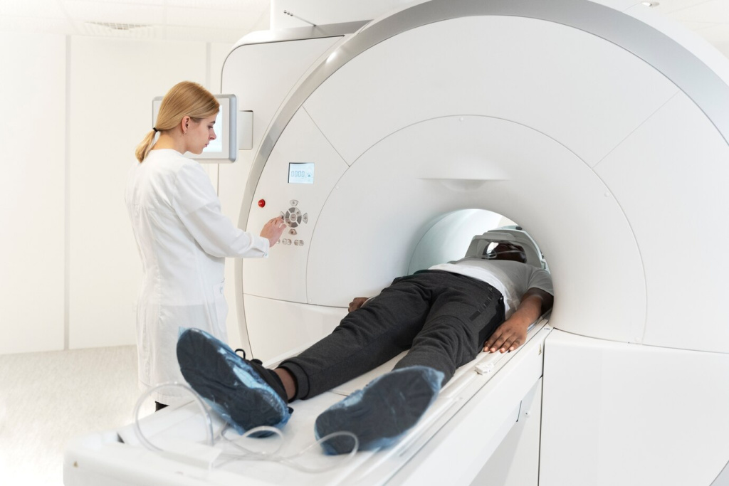 high-angle-young-doctor-pressing-ct-scan-buttons_23-2149341516.jpg